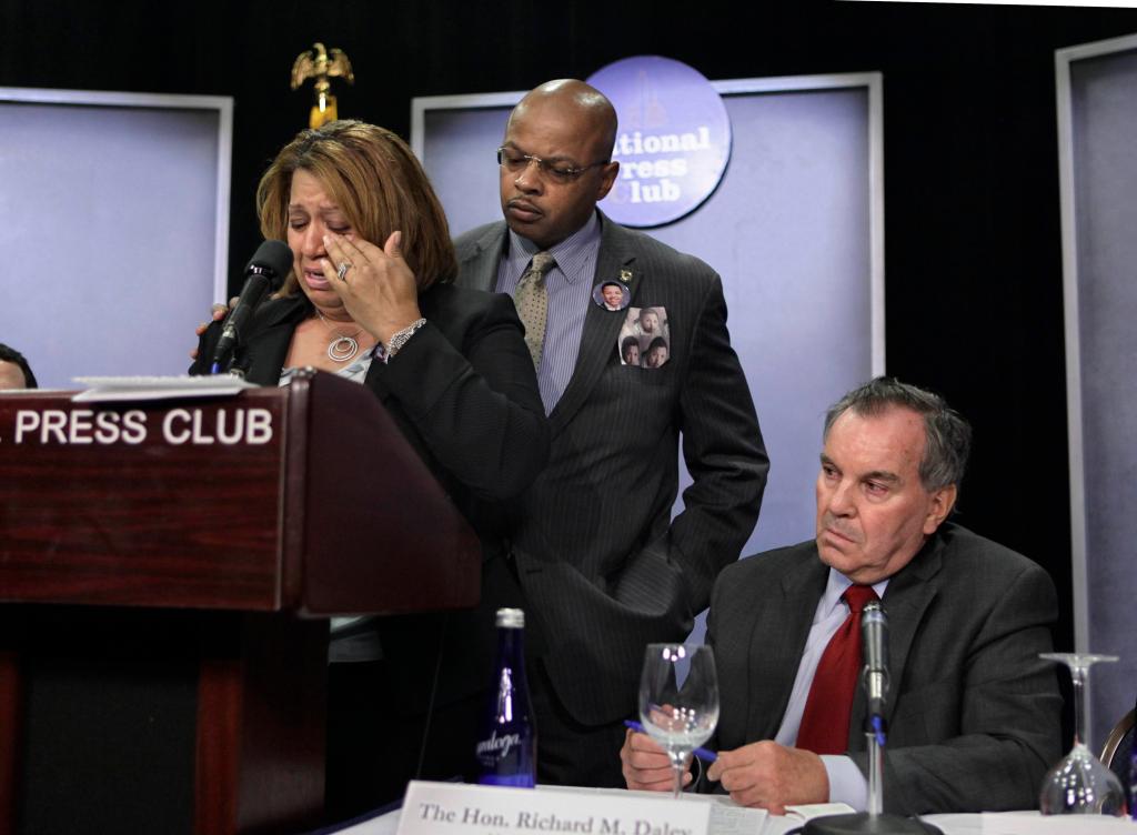 Chicago firefighter Annette Nance-Holt, left, weeps as she recalls the death of her son, Blair, who was a victim of gun violence, during a news conference this month in Chicago. Behind her is her husband, Chicago Police Officer Ronald Holt. At right is Chicago Mayor Richard M. Daley. The Supreme Court this week will consider a gun rights case: McDonald v. Chicago.