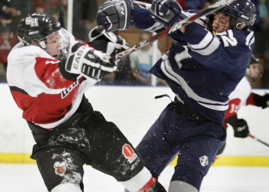Marshall Brunelle, right, of Yarmouth collides with Wayne Neiman of Camden Hills during their Western Class B semifinal at Portland Ice Arena. Yarmouth advanced to the regional final with a 3-1 victory.