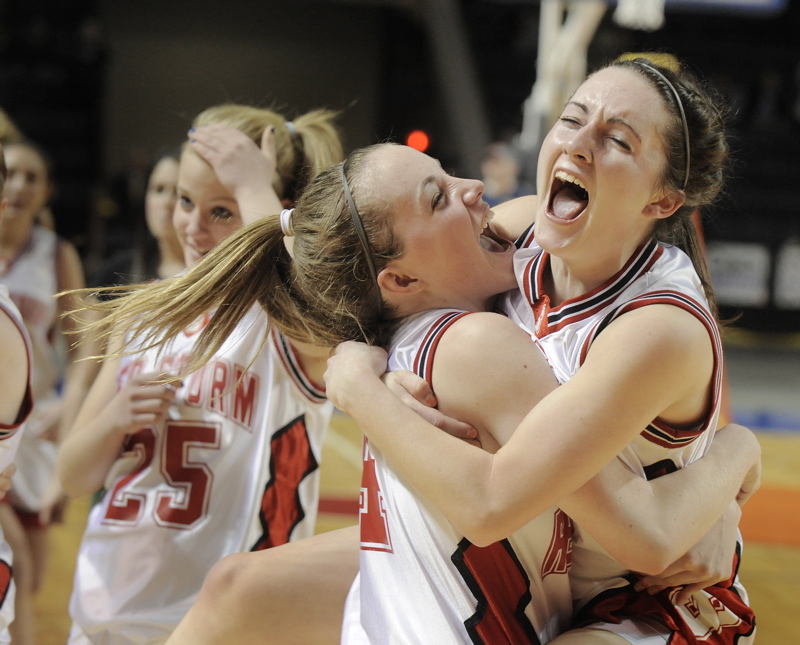 Heather Carrier, left, and Brittany Ross embrace after Scarborough, on a winning basket by Christy Manning with 11.8 seconds remaining, overcame Deering for a 37-34 victory in Western Class A championship game. Scarborough will meet Skowhegan in the state final.