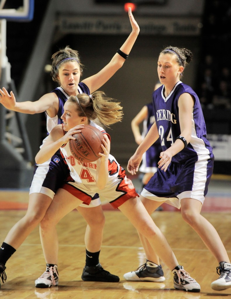 Heather Carrier of Scarborough looks for help while guarded by Maria Salamone, left, and Ella Ramonas of Deering.