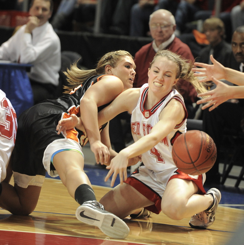 Heather Carrier, right, of Scarborough and Jaimi Poland of Skowhegan scramble to recover a loose ball during Scarborough’s 52-32 victory in the Class A final.