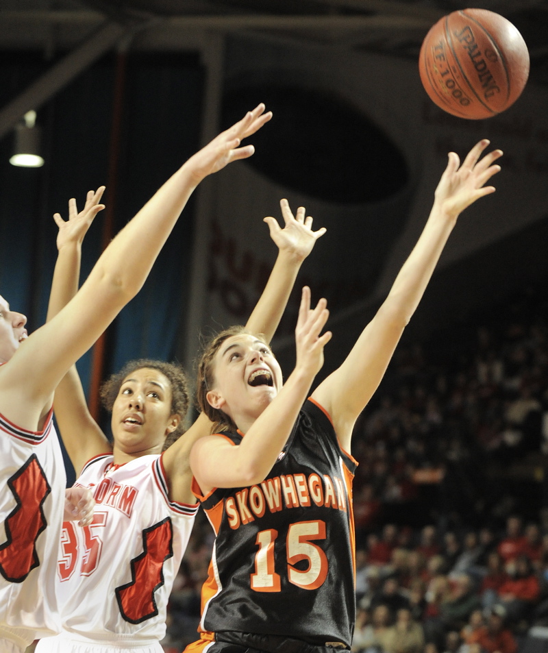 Adrienne Davis of Skowhegan slips through the Scarborough defense on her way to the basket.