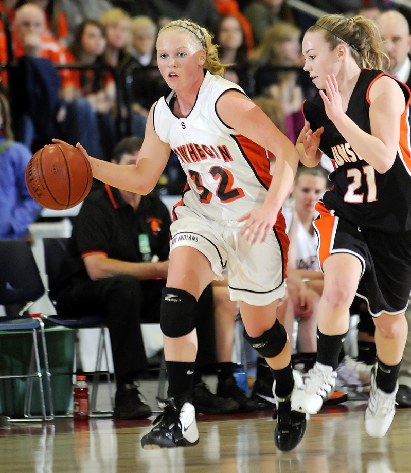 Skowhegan guard Whitney Jones dribbles up the court with Jacquelyn Kelly in pursuit.
