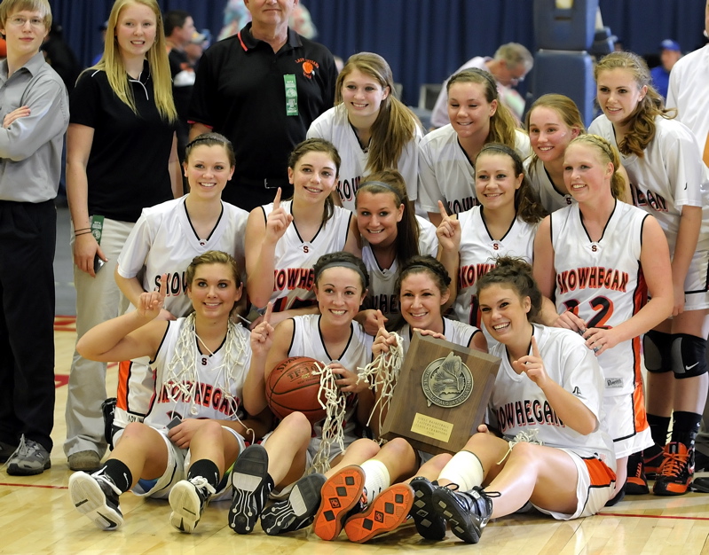 Skowhegan players pose with their championship plaque after winning the Eastern Class A title.