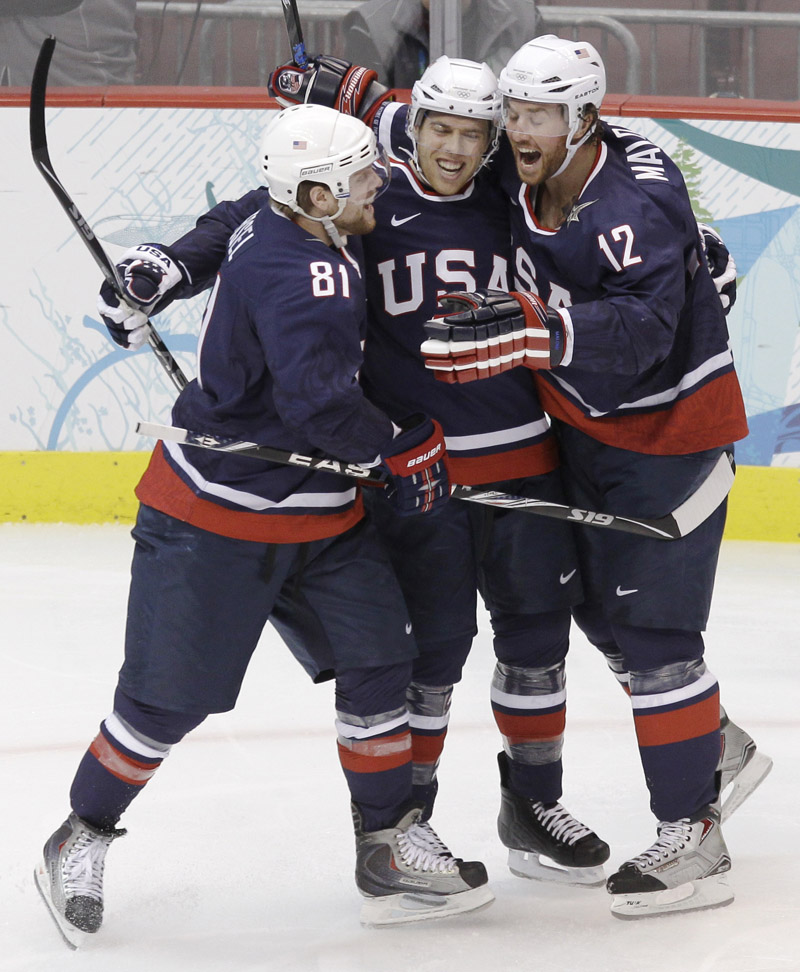 Ryan Malone, right, celebrates with Phil Kessel, left, and Joe Pavelski after scoring the opening goal Friday for the U.S. in a 6-1 semifinal victory over Finland.