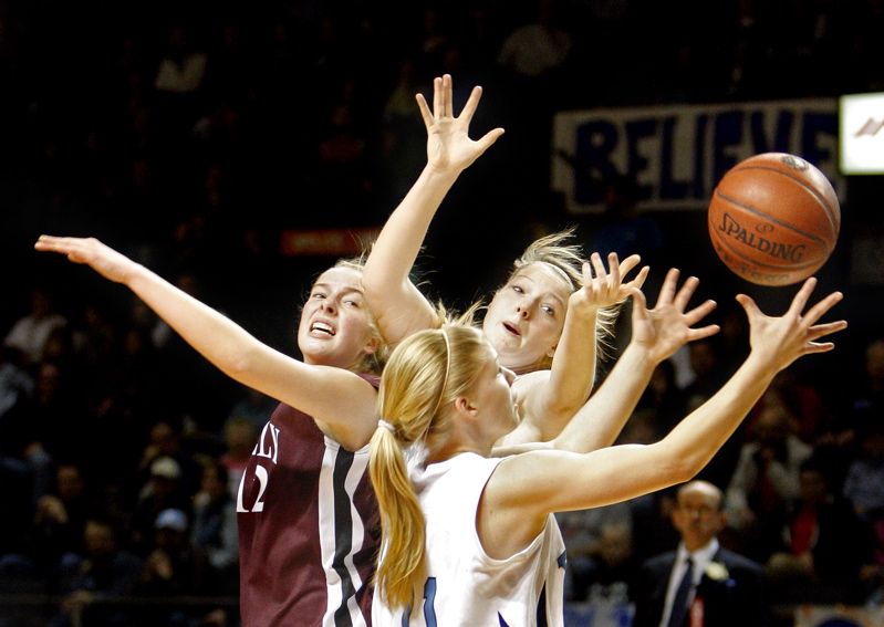 Andrea Mountford of York pulls in a rebound alongside teammate Nicole Taylor and Greely’s Abby Young during the Western Class B championship game at the Cumberland County Civic Center. York won, 50-38.