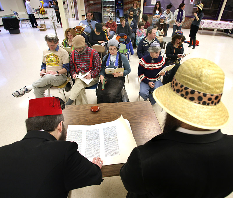 Yossi Freidman, left, and Rabbi Moshe Wilansky begin the celebration with the Megilah reading, which tells the story of Purim.