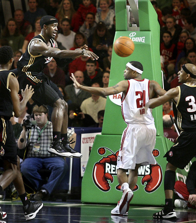 Maurice Ager of the Red Claws gets caught in the middle as Erie’s Cedric Jackson flips a pass toward teammate Ivan Harris during Sunday’s game at the Portland Expo. Portland held on for a 102-95 victory.