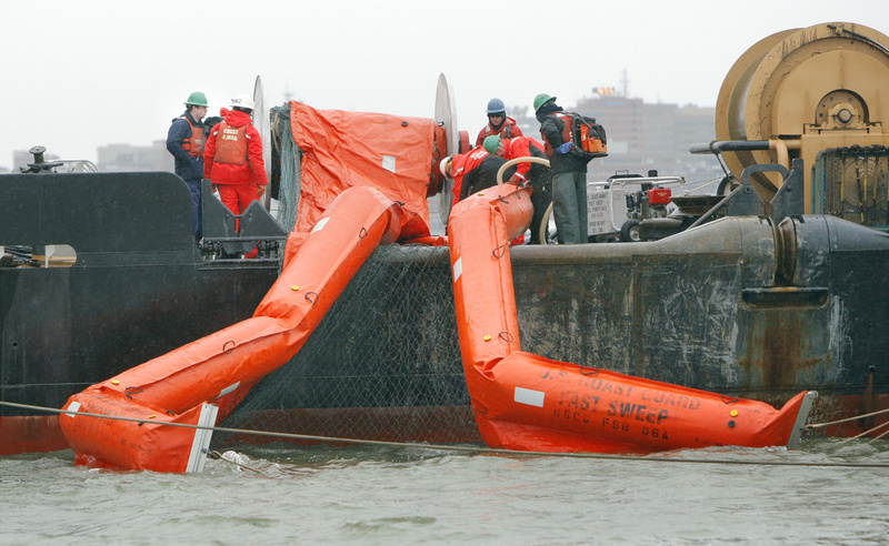 A crew aboard the Marcus Hanna deploys containment booms Wednesday during an oil spill exercise in Portland Harbor. More than 500 people from dozens of public agencies and private businesses are participating in the two-day test of the region’s emergency response system.