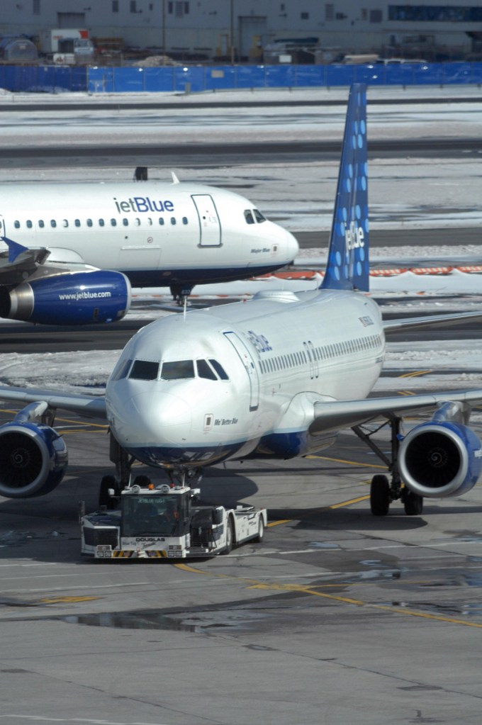 A JetBlue Airbus A320 taxis past another JetBlue plane being towed to a gate at John F. Kennedy International Airport in New York. The main runway at the airport will be closed for four months starting today.