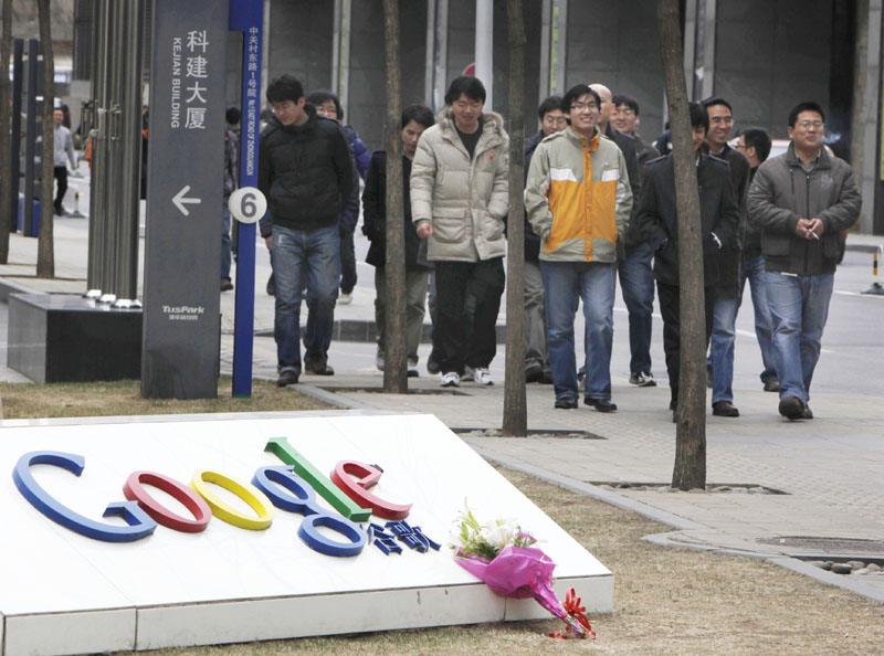 A bouquet of flowers rests on the Google logo outside the Google China headquarters in Beijing today.
