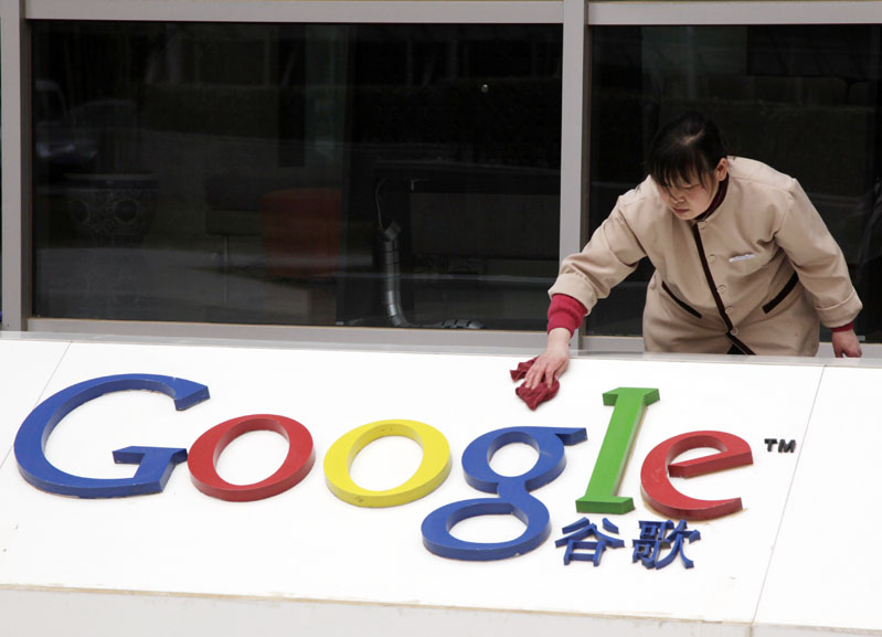 A worker cleans the sign in front of Google China headquarters in Beijing today.