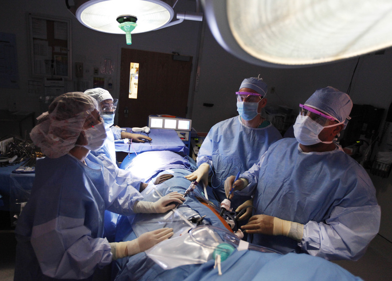 Dr. Keith Melancon, right, performs surgery to harvest a kidney at Georgetown University Hospital in Washington, D.C. Of all U.S. health care businesses, most experts say hospitals stand to benefit the most from the expansion of health insurance.