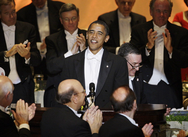 In this 2008 file photo then-presidential candidate Sen. Barack Obama is applauded as he speak during the Alfred E. Smith Dinner at the Waldorf Astoria Hotel in New York. Obama had them in stitches with a sendup of his fawning treatment by the national media. "Contrary to the rumors you have heard, I was not born in a manger," he said. "I was actually born on Krypton and sent here by my father Jor-El to save the Planet Earth."