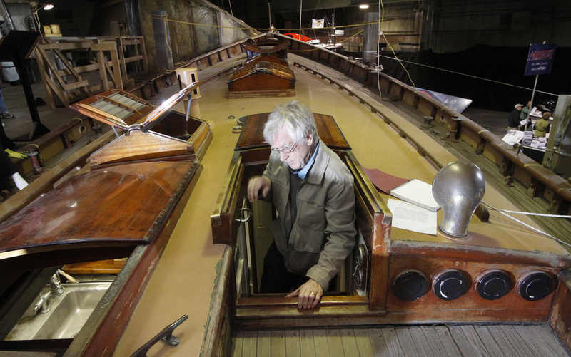 Jos Ruks of Portland climbs onto the deck of the Tar Baby, a 50-foot classic wooden yacht designed by John Alden and built by C.A. Morse & Son in Thomaston in 1929. He was among thousands of people who visited the Maine Boatbuilders Show, held Friday to Sunday. Below, Brian and Liz LaPoint of Rochester, N.H., stroll through the living quarters of the Alden Schooner Lion’s Whelp, designed and built by Phineas Sprague.