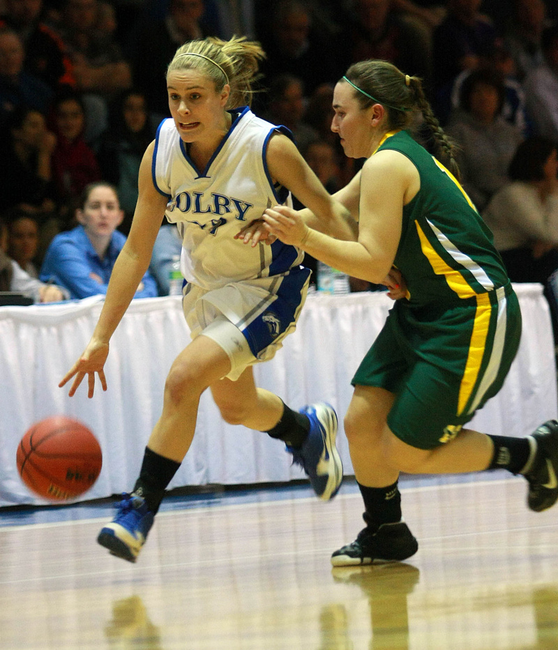 Diana Manduca of Colby, the former Deering High standout, dribbles past Caitlyn Butterfield of Husson during their NCAA Division III tournament game Friday night. Colby came away with a 62-59 victory at home.