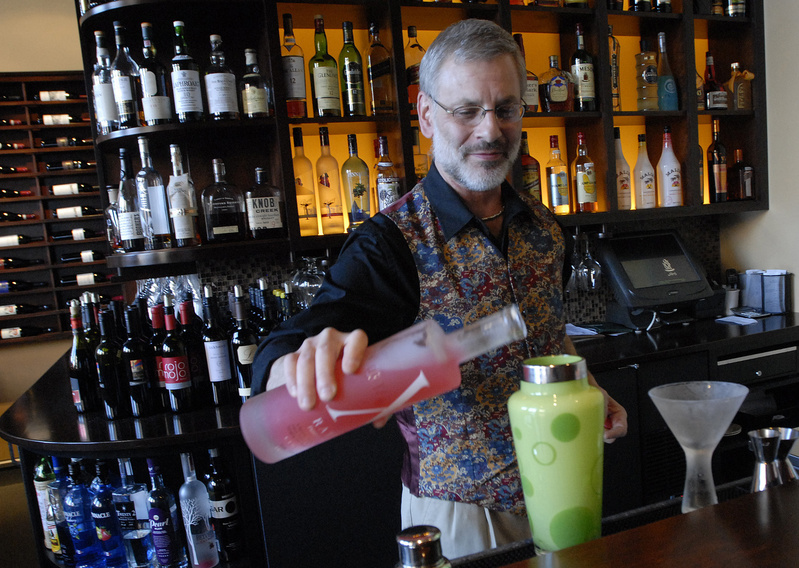 Steve Lovenguth, bar manager at Walter’s, mixes a Union of Four, which combines Domaine de Canton ginger liqueur, Hypnotiq liqueur, St. Germain elderflower liqueur, X-Rated Fusion liqueur and passion fruit juice.