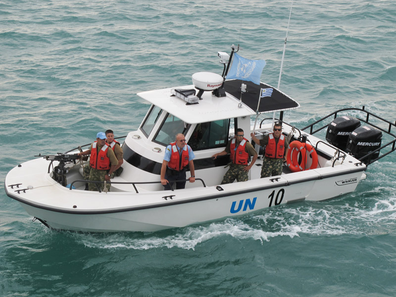 A United Nations Police patrol boat arrives at the Sea Hunter's anchorage this morning to provide security while the ship offloads its relief supplies.
