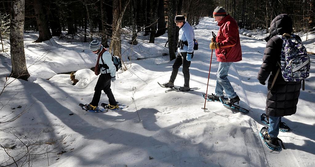 Bridie McGreavy leads a group into the Holt Preserve to identify animal tracks. From left are McGreavy, Leigh Hayes of Bridgton, Derby Cartmill of Casco and Miriam Gibely of Sweden.