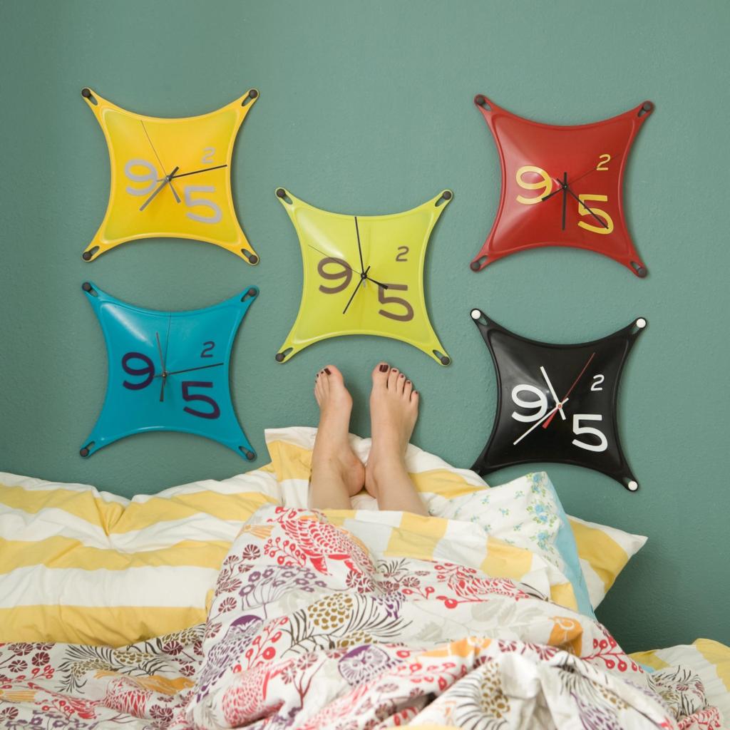 Stretch clocks made of silicone, created by SCAD graduate Charles Heidlinger, grace a wall.