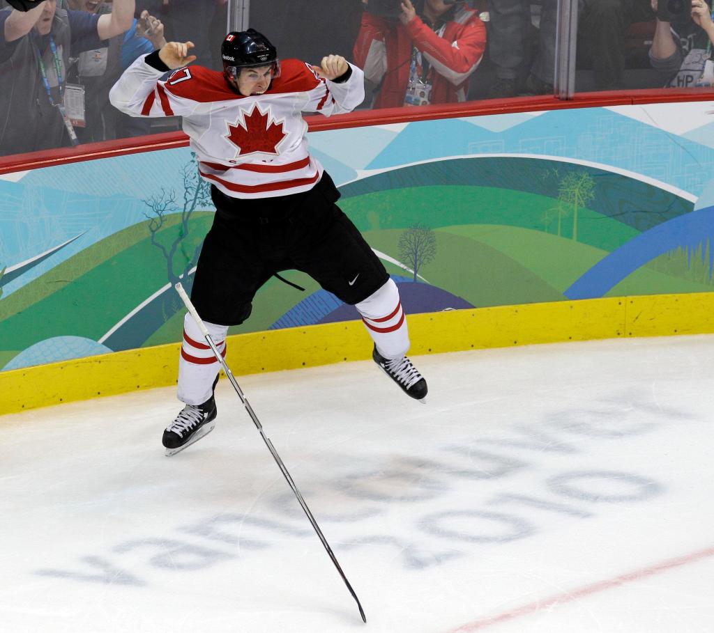 Sidney Crosby leaps for joy after stuffing a pass from Jarome Iginla through the pads of U.S. goalie Ryan Miller in overtime to give Canada a 3-2 victory and a gold medal in men’s hockey Sunday on the final day of the Vancouver Winter Olympics.