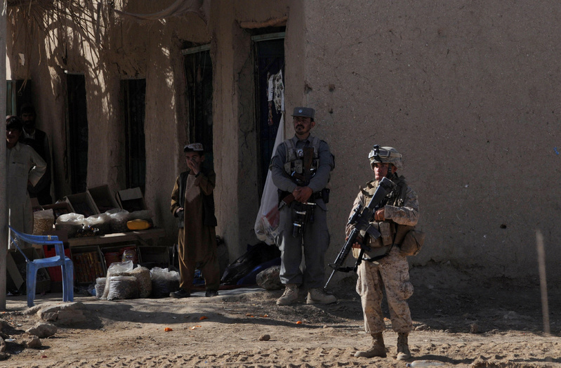 A U.S. Marine stands guard Monday in Marjah, Helmand province. In the coming days and weeks, with Marines providing a backbone of security, Afghan officials will reopen schools, expand critical irrigation system and set up the government.