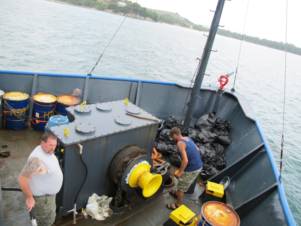 Chief engineer Brian Ryder of West Bath, left, and volunteer Rick Woodbury of Scarborough set the Sea Hunter’s anchor Tuesday off the Haitian port of Les Cayes.
