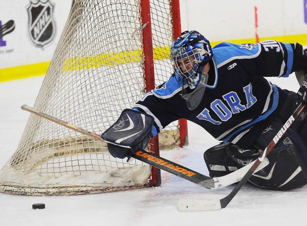 York goalie Alex Ahrikenchikh reaches with his stick for the puck Saturday during the 3-1 loss to Brewer in the Class B state championship game at Lewiston. Ahrikenchikh made 19 saves.