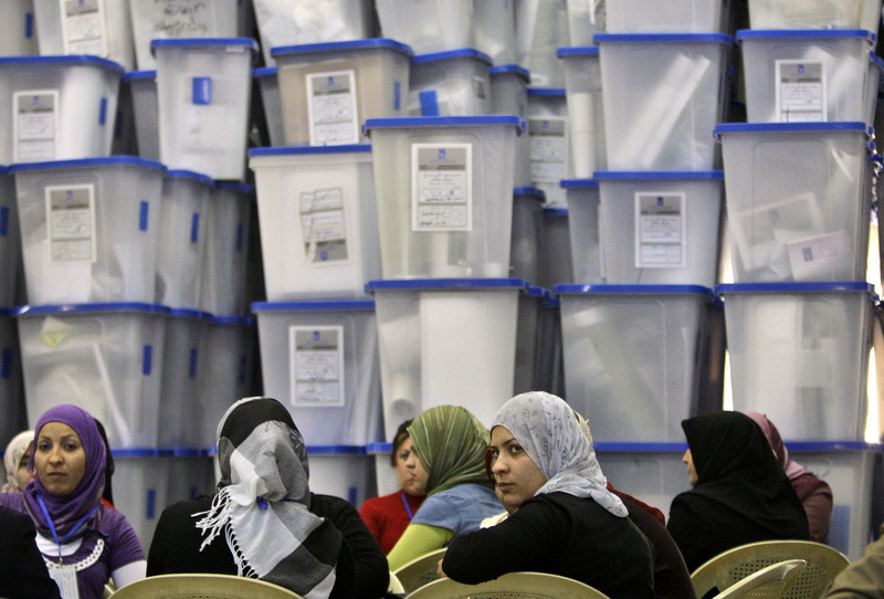 Electoral workers sit in front of piles of ballot boxes at a counting center in Baghdad, Iraq, on Monday. The conclusion of Sunday’s vote does not spell an immediate end to Iraq’s political uncertainty, as it could be days until results come in and it could take months to form a government.