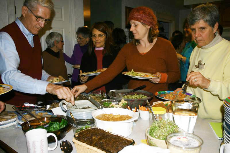 Phil Coupe, Karen Wildwood, Lisa Silverman and Carol Landry help themselves to the delicious whole foods at this month’s macrobiotic potluck.