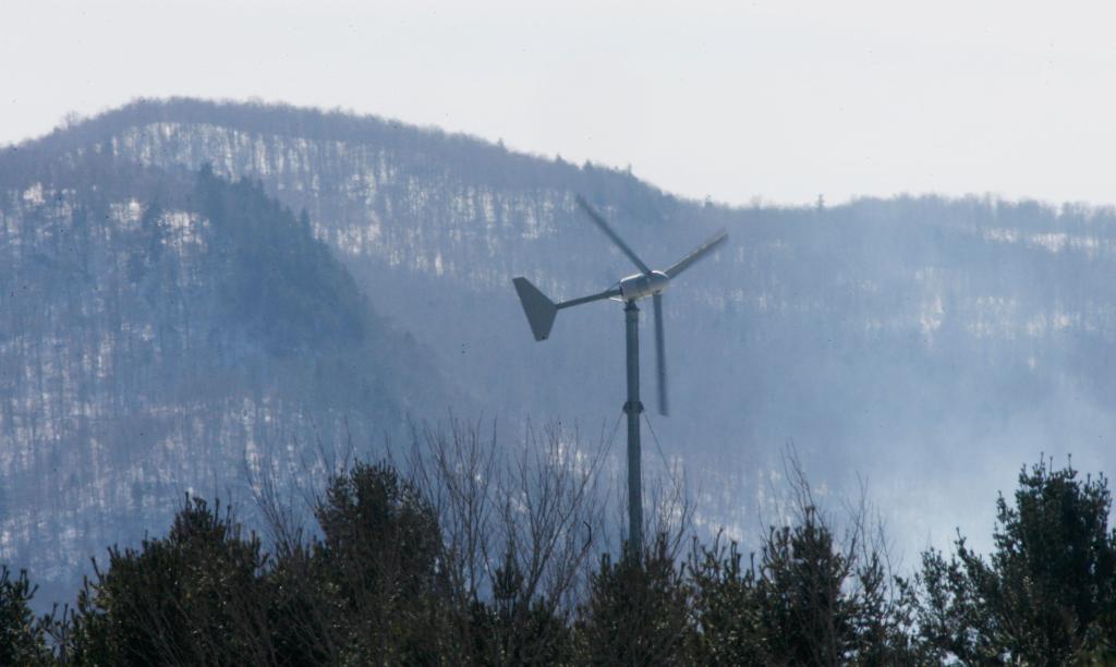 A windmill in Vermont occupies a forested, mountainous site. Proposed Maine wind farms would be built on similar terrain.