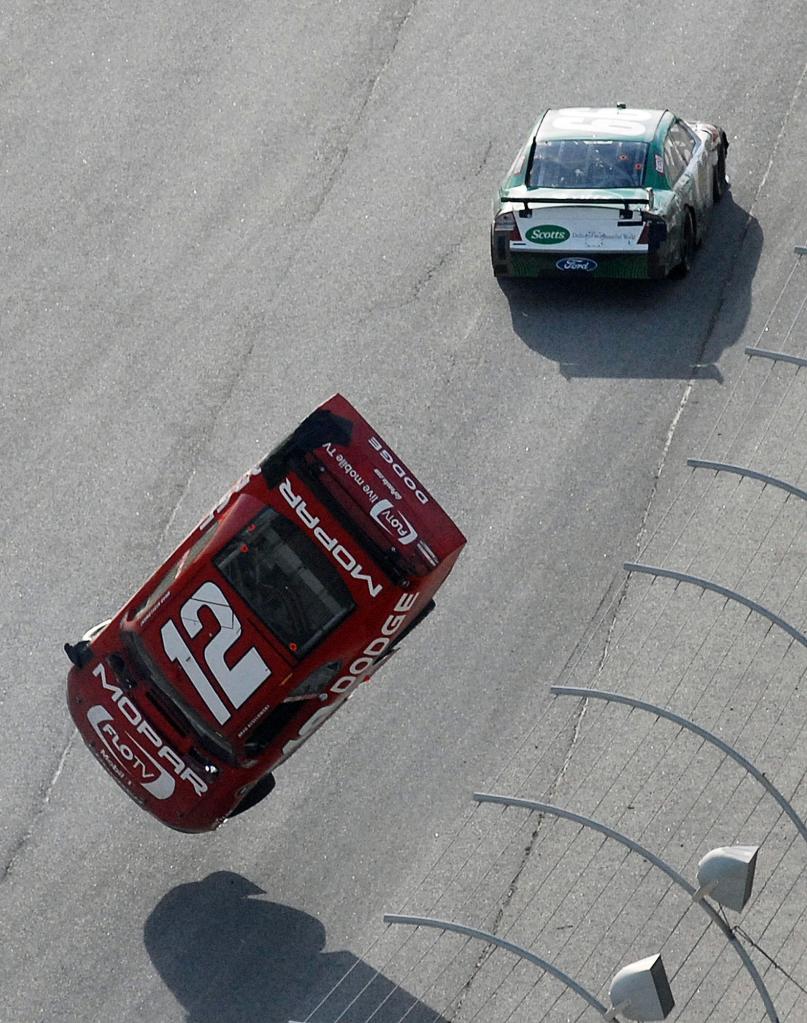 Carl Edwards drives on past after an intentional nudge that sent Brad Keselowski into a spectacular flip that endangered the driver and fans alike after the No. 12 hit the wall.