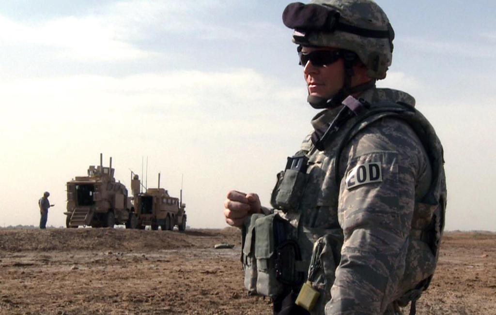 Tech Sgt. Jeremy Phillips waits for his team members to prepare a detonation outside of Forward Operating Base Garry Owen on Monday in Maysan province, Iraq. In real life, bomb technicians break out their bulky bomb suits only as a last resort, preferring the safer means of disarming bombs remotely.
