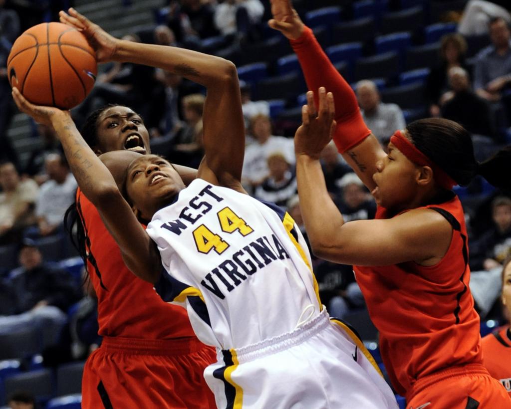 Madina Ali of West Virginia tries to put up a shot while facing double-team pressure from Rutgers during the Big East semifinals Monday night at Hartford, Conn. No. 9 West Virginia advanced with a 56-49 victory.