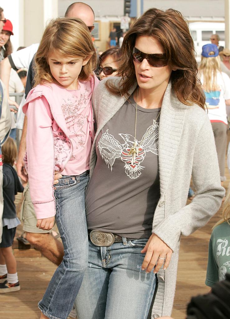 Supermodel Cindy Crawford carries her daughter Kaya Gerber in October 2006. A photo of the bound child taken during a “cops and robbers” game was used in an extortion plot.