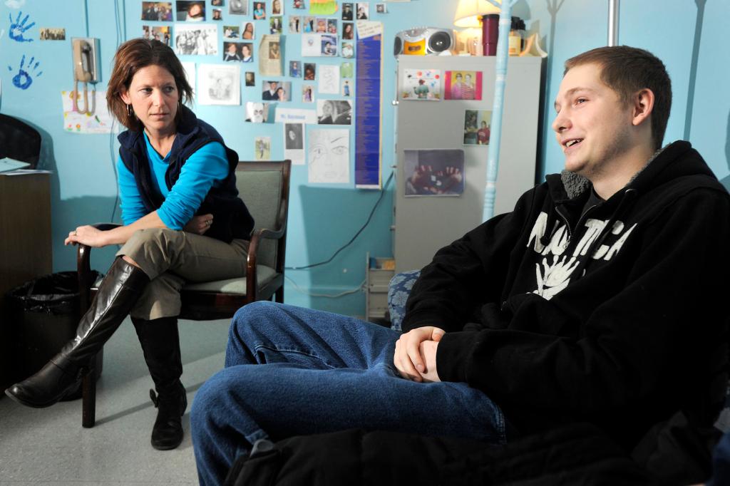Sophie Payson, a social worker in Portland High School's alternative education program talks with senior Leo Smith. “She wasn’t going to give up on me,” Smith says of Payson.