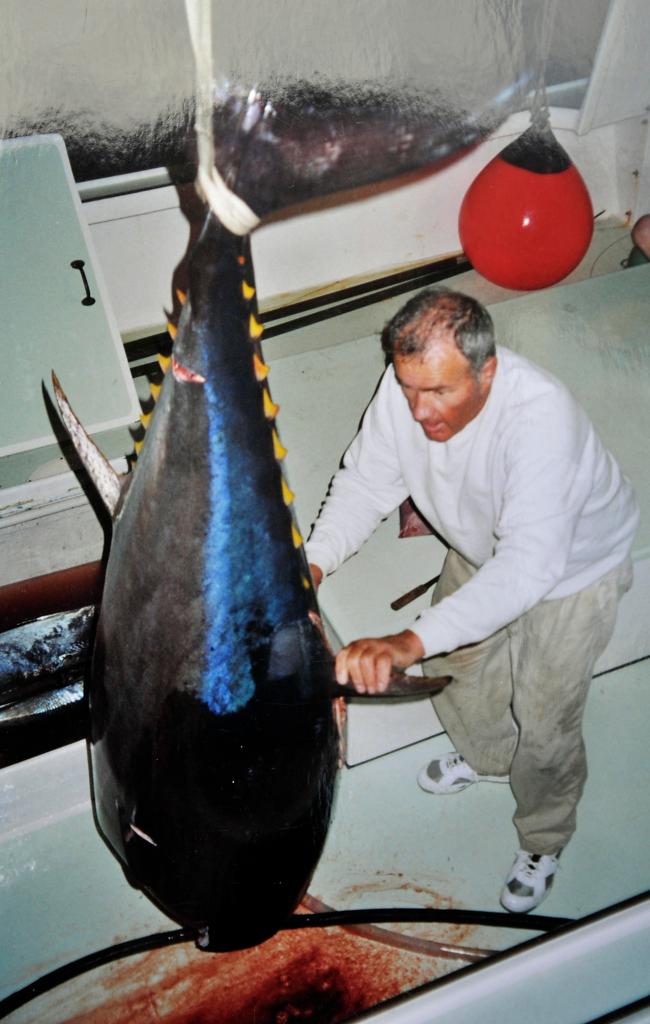 David Linney removes from a cold-storage area one of six bluefin tuna he caught on a productive day in July 2004.