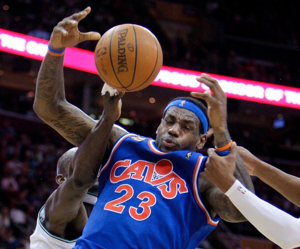 LeBron James of Cleveland takes a pounding as he goes up for a shot Sunday against Boston, which failed to keep pace with the Cavaliers in a 104-93 loss.
