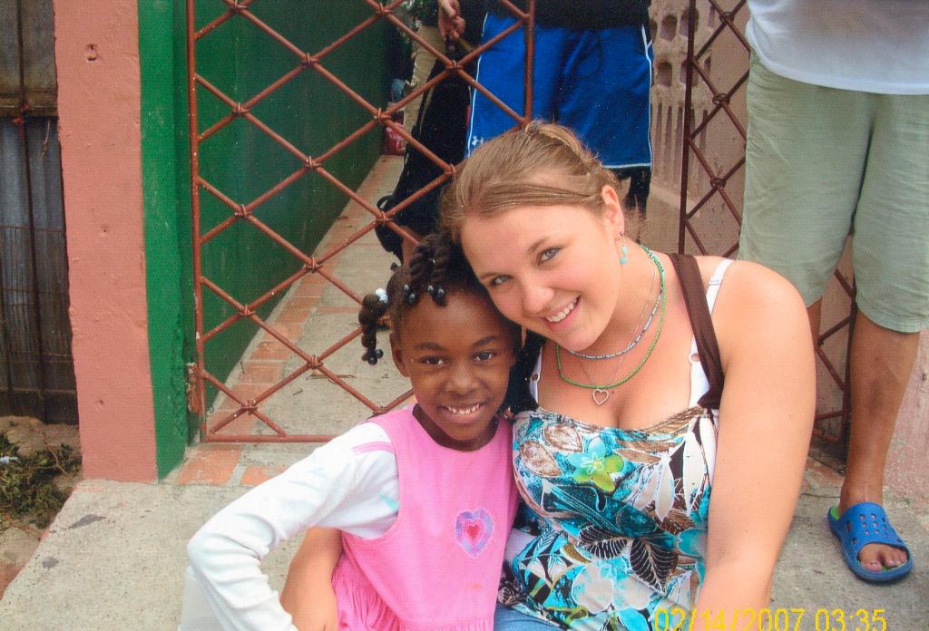 Courtney Connolly, a former dropout who is a senior at Portland High School, poses with a child she met while helping Seeds of Independence provide health care to sugar cane workers in the Dominican Republic last year. Connolly will return to the Caribbean country next week for a second stint with the Freeport nonprofit that helps at-risk teenagers.
