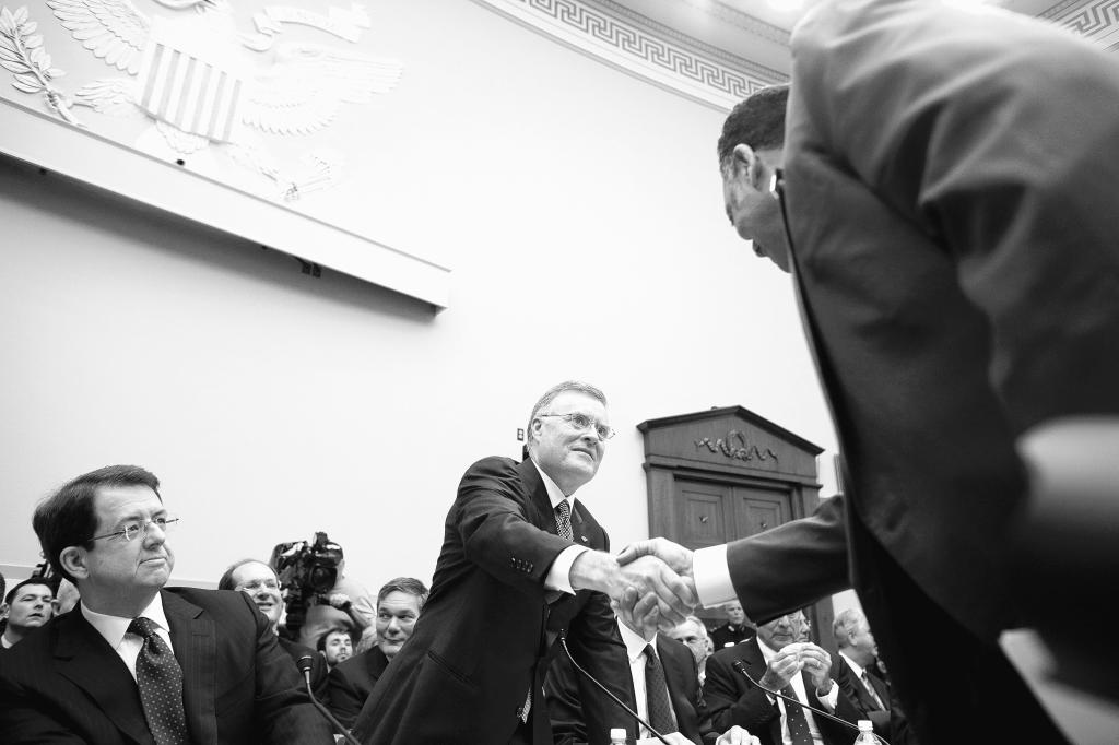 Ken Lewis of Bank of America shakes hands with the Rev. Jesse Jackson on Feb. 11, 2009, before testifying before the House Financial Services panel on how financial institutions have spent funds received from the Troubled Asset Relief Program. Recent court actions are putting pressure on the Federal Reserve to reveal information about those emergency loans.
