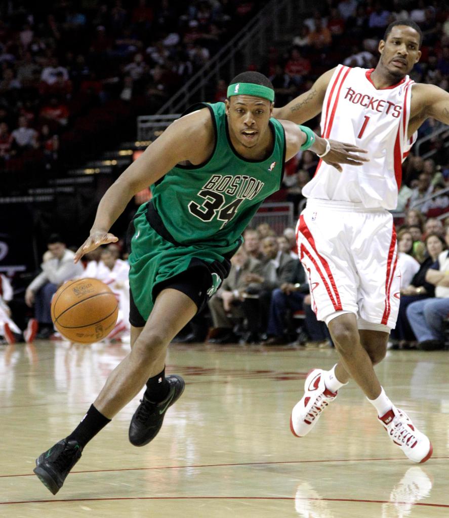 Boston’s Paul Pierce drives past Houston’s Trevor Ariza during the first quarter Friday night in Houston. Pierce scored 26 points and Ray Allen had 19 to lead the Celtics.