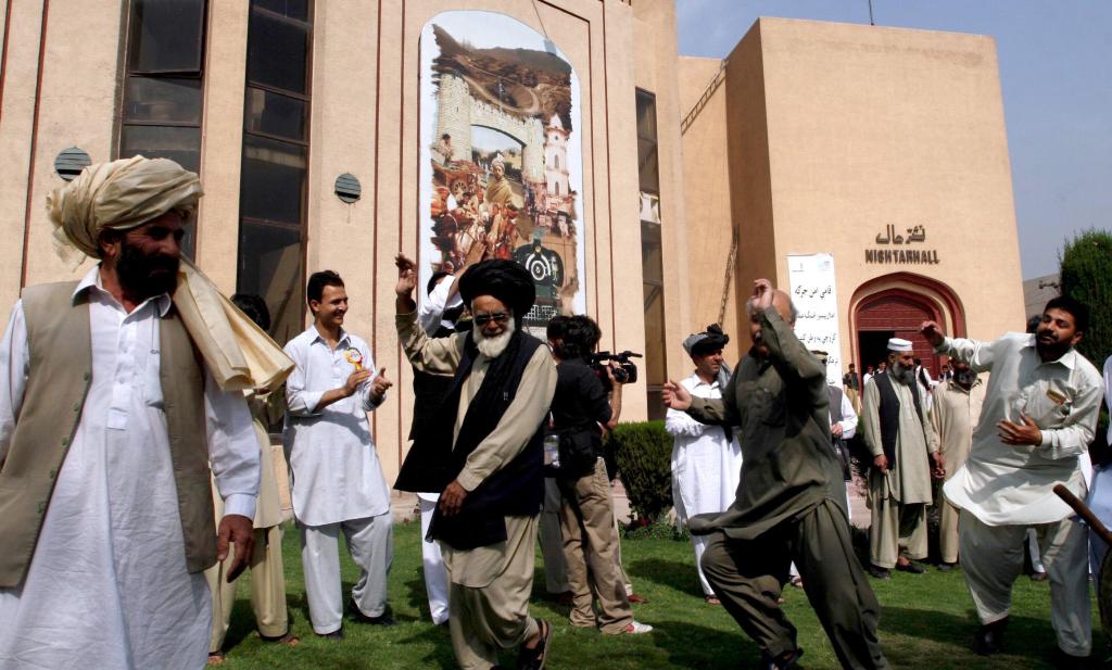 Pakistani tribesmen participate in traditional dance after tribal leaders gathered in Peshawar on Saturday. Hundreds of tribesmen from near the Afghan border took part in the meeting.