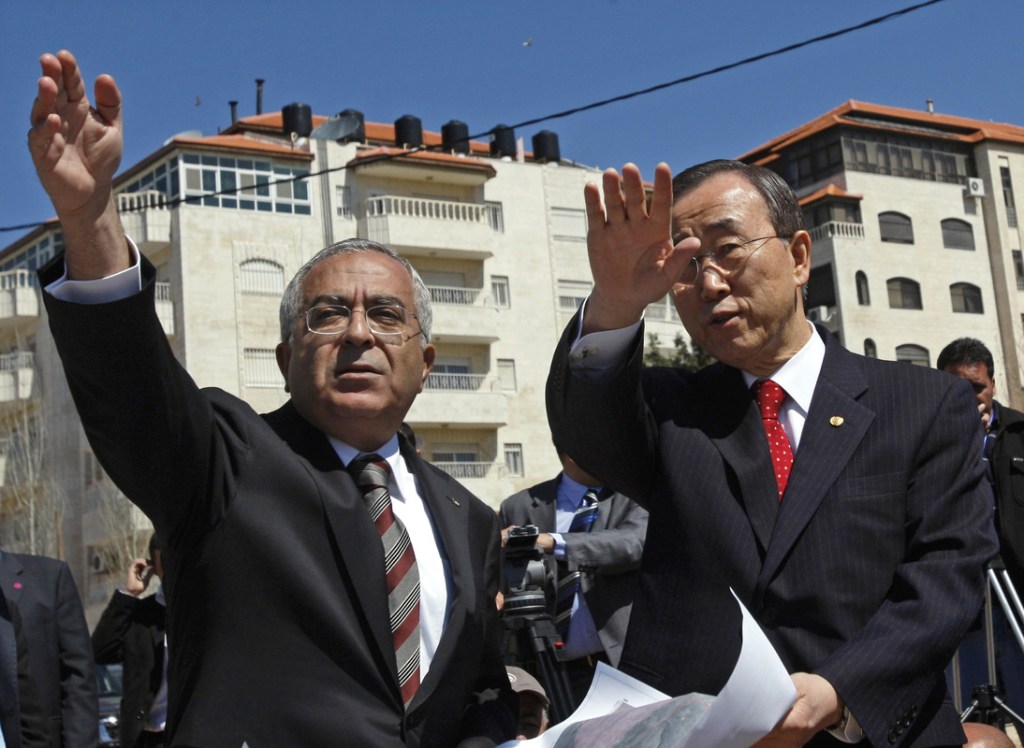 U.N. Secretary-General Ban Ki-moon, right, looks over Israeli settlements with Palestinian Prime Minister Salam Fayyad during a tour of the West Bank city of Ramallah on Saturday.