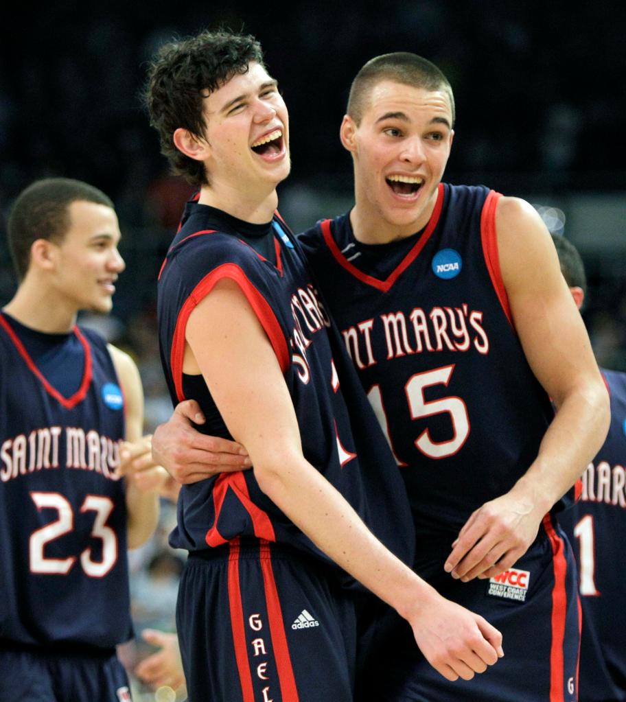Saint Mary's Trey Anderson (23), Clint Steindl, center, and Beau Levesque celebrate after beating Villanova 78-65 on, Saturday.