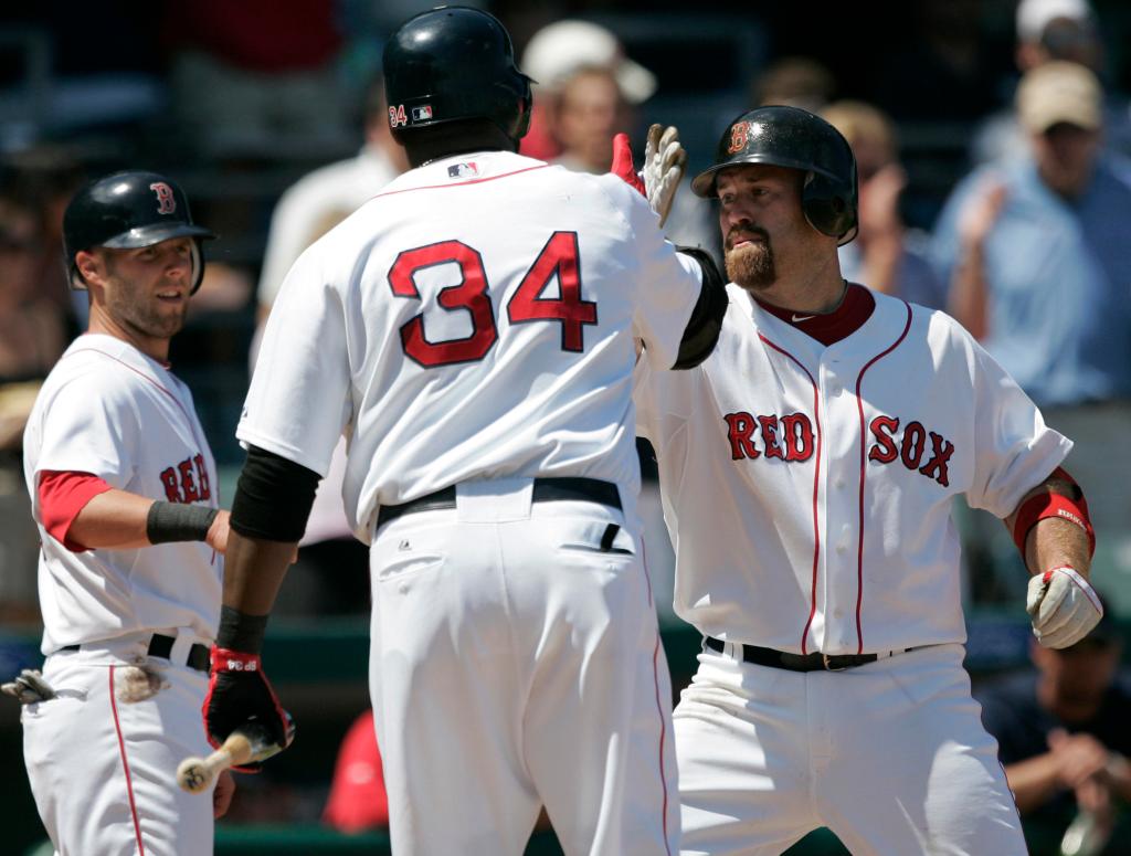 Kevin Youkilis of the Boston Red Sox, right, is greeted by David Ortiz, foreground, and Dustin Pedroia after hitting a two-run homer Saturday during a 6-0 victory over the Orioles.