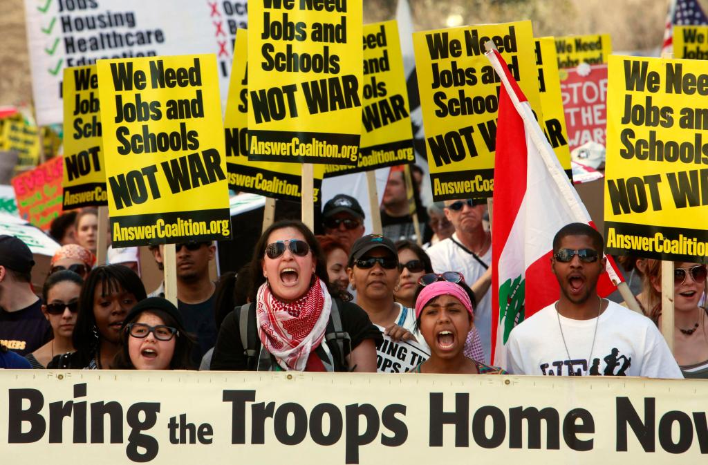 Anti-war protesters march through Washington on Saturday to protest the wars in Iraq and Afghanistan on the seventh anniversary of the invasion of Iraq. Despite at least eight arrests, the rally was peaceful.