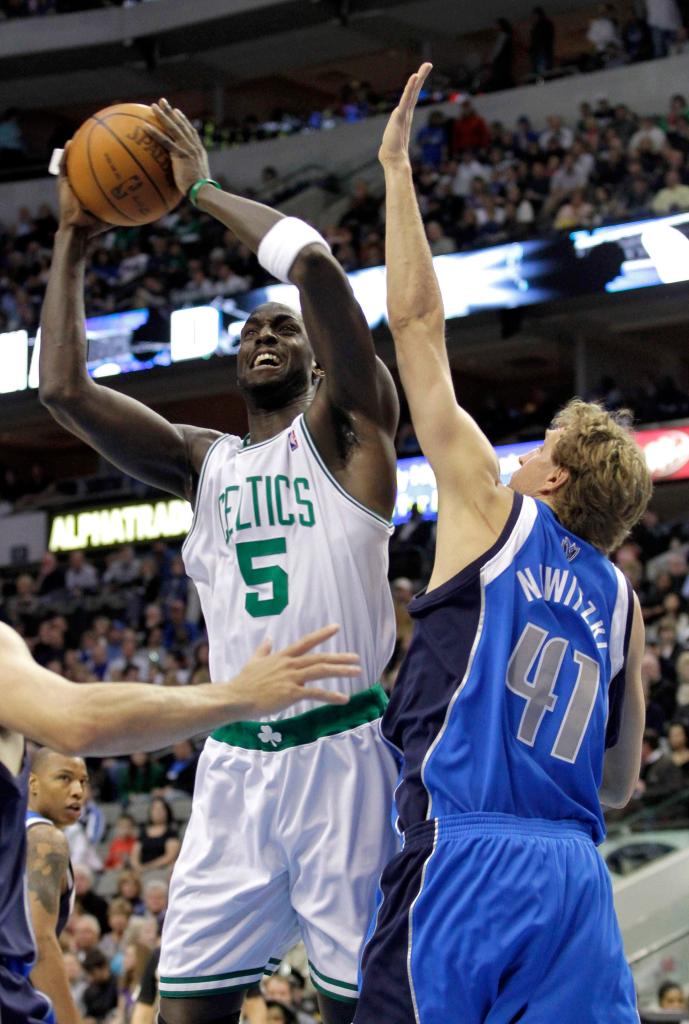 Kevin Garnett of the Boston Celtics heads to the basket in the first quarter Saturday night while guarded by Dirk Nowitzki of the Dallas Mavericks. Boston won, 102-93.