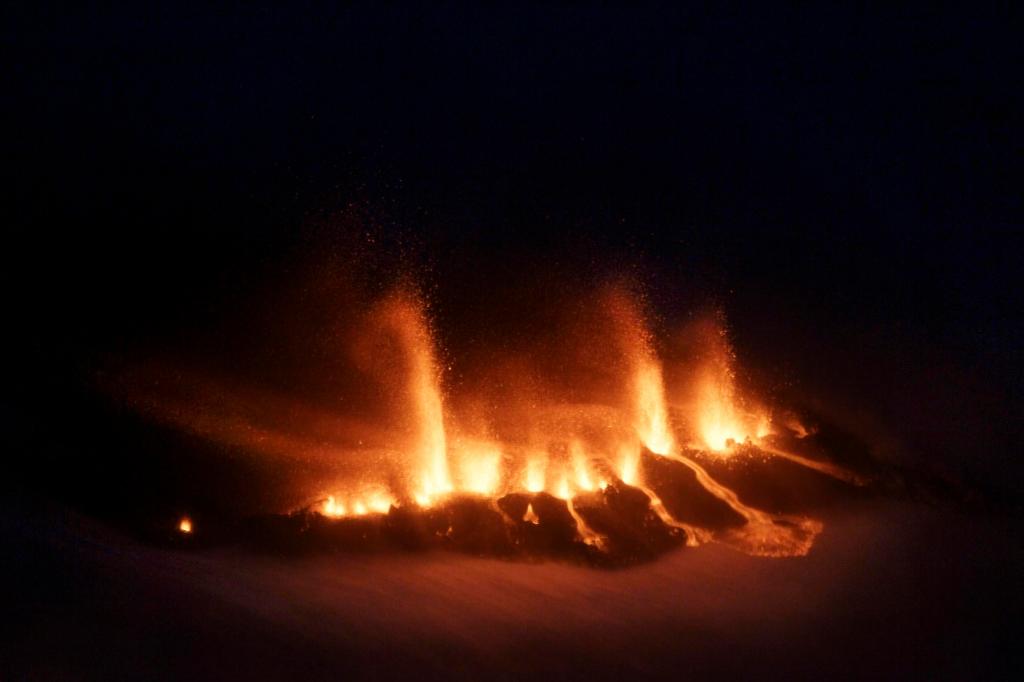 Aerial photo shows molten lava as it vents from a rupture near the Eyjafjallajokull glacier in Iceland, as a volcano erupts Sunday. Hundreds of people were evacuated from a small village in southern Iceland after the eruption shot ash and molten lava into the air, the first major eruption here in nearly 200 years.