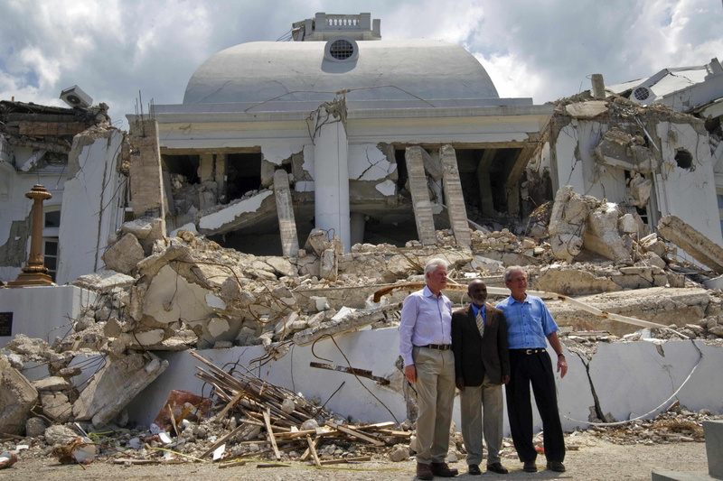 Haitian President Rene Preval, center, former President George W. Bush, right, and former President and U.N. special envoy for Haiti Bill Clinton pose Monday in front of the earthquake damaged national palace in Port-au-Prince.