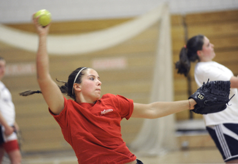 Erin Giles, a freshman at Scarborough High, winds up Monday, the opening day of practice for Maine high school softball and baseball pitchers and catchers. She says pitching from 43 feet instead of 40 feet won’t require much of an adjustment.